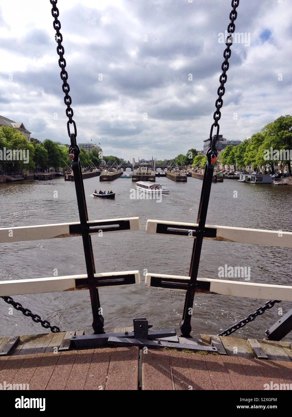 View from Magere Brug bridge along the Amstel in Amsterdam Netherlands Stock Photo