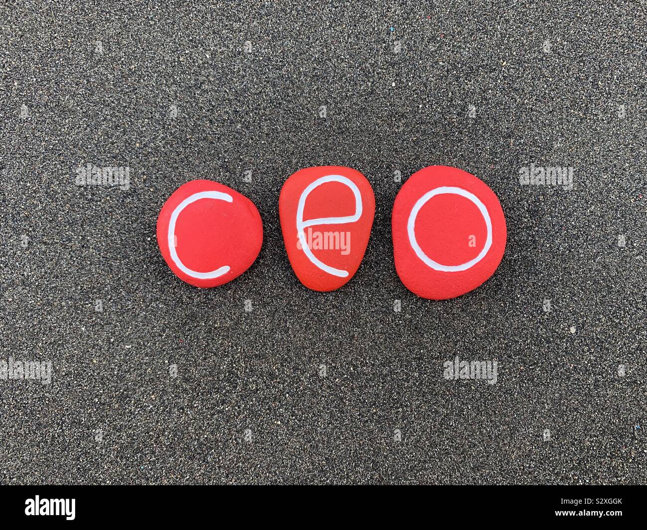 Ceo, Chief Executive Officer composed with red colored stones over black volcanic sand - Smartphone Captured Stock Image