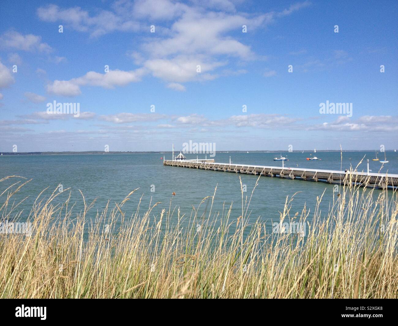 Yarmouth pier and the Solent in the Isle of Wight Stock Photo