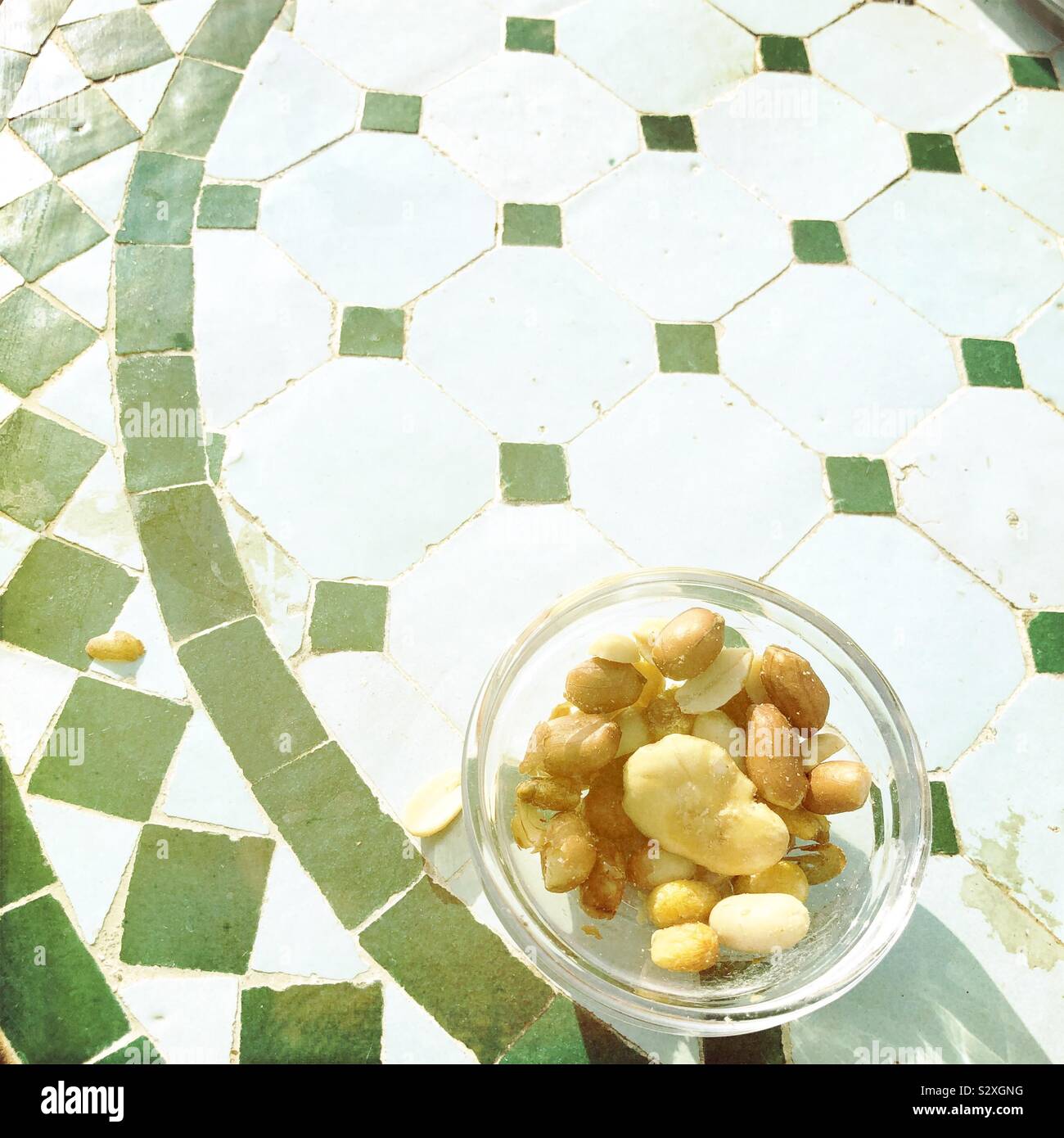 Small bowl of mixed nuts on a rustic table, Spain - Smartphone Captured Stock Image