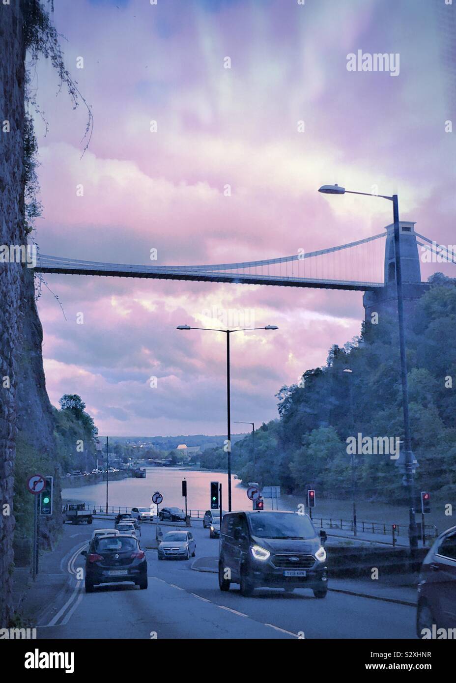 Evening traffic along the Avon Gorge, with the Clifton Suspension Bridge ahead Stock Photo