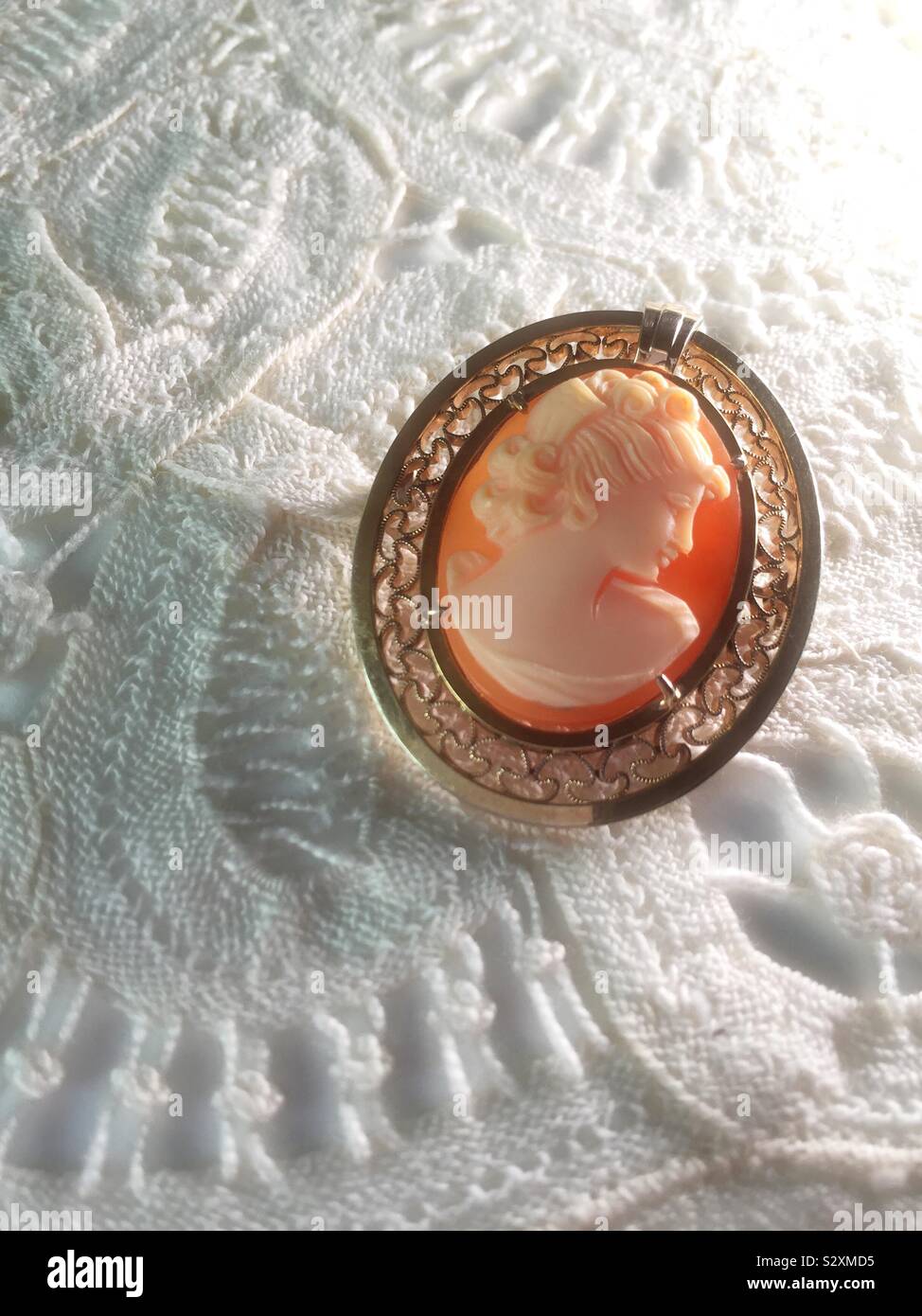 Vintage Italian cameo brooch on a lace background Stock Photo - Alamy