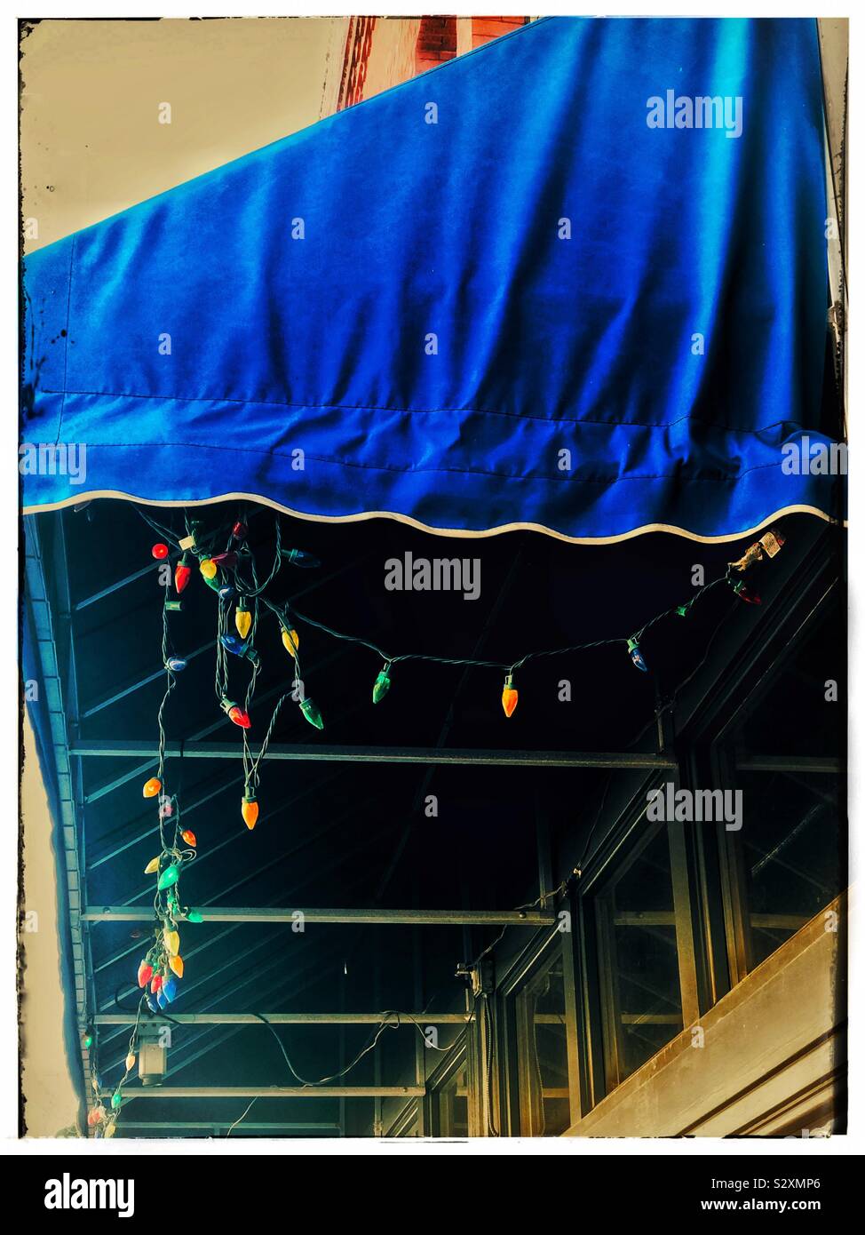 Blue awning with hanging colored lights Stock Photo
