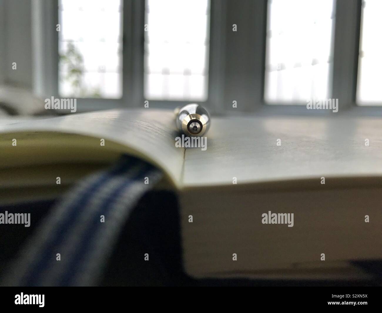 Ballpoint pen resting on open notebook. - Smartphone Captured Stock Image