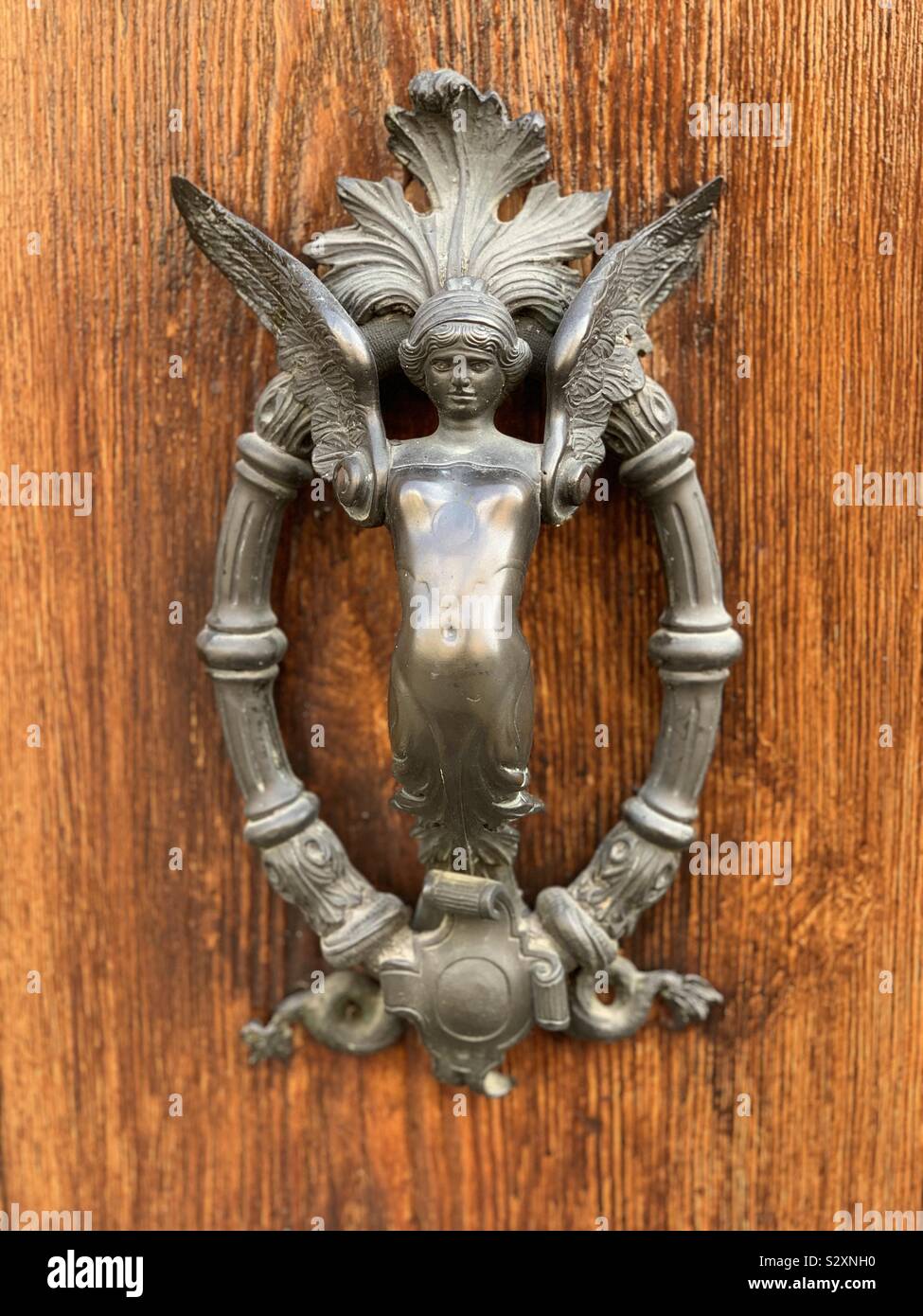 Artistic clapper handle in form of a winged woman - Smartphone Captured Stock Image