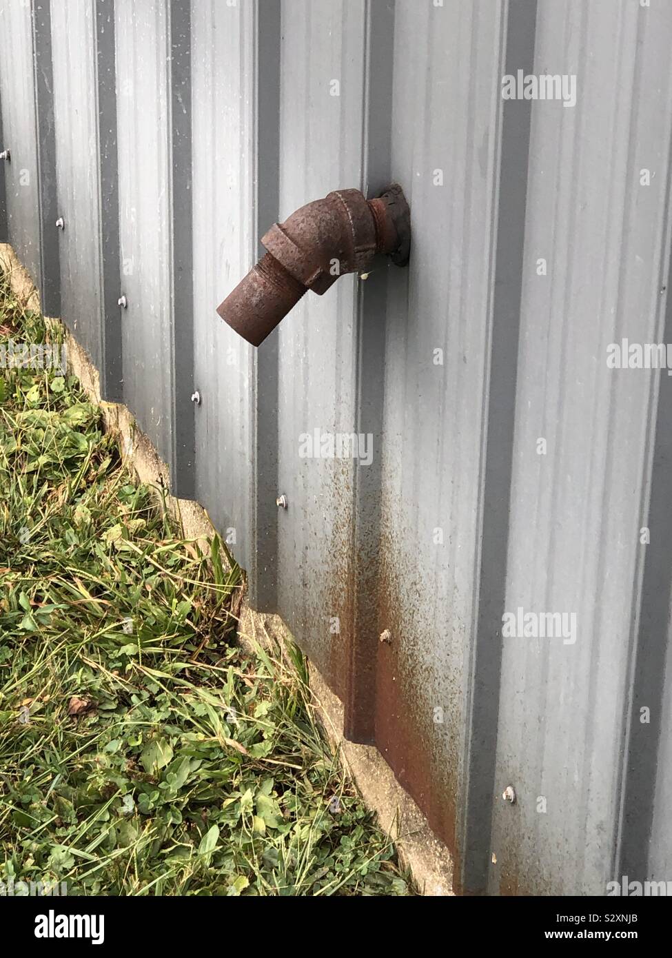 Rusty water pipe on side of building Stock Photo Alamy