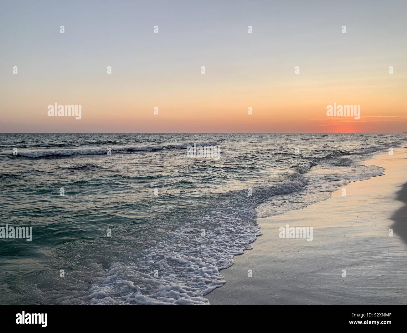 Ocean view with sunset skies, waves as sun has left the horizon - Smartphone Captured Stock Image