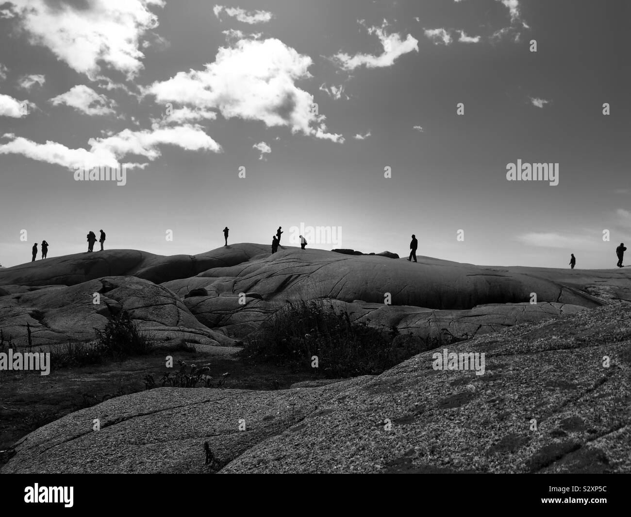 Silhouettes of people wandering on a rocky hillside - Smartphone Captured Stock Image