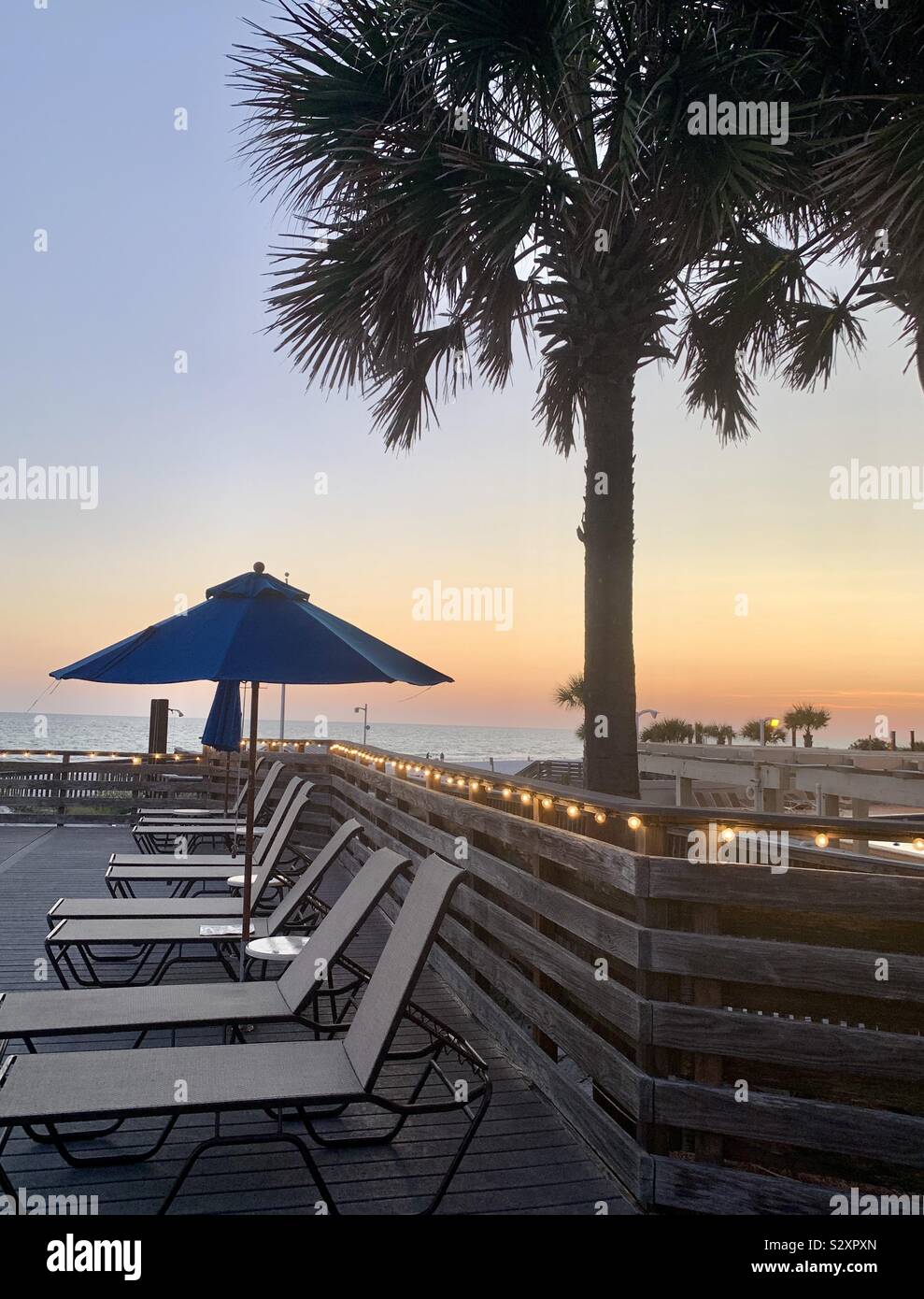 Sunset beach chairs palm trees hires stock photography and images Alamy