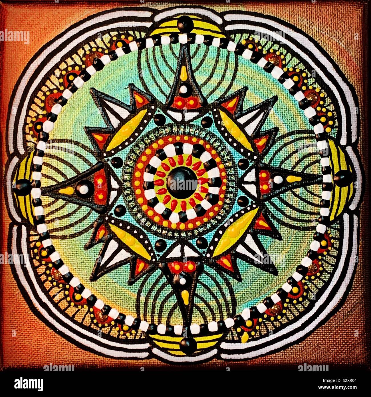 Golden mandala design on canvas. - Smartphone Captured Stock Image
