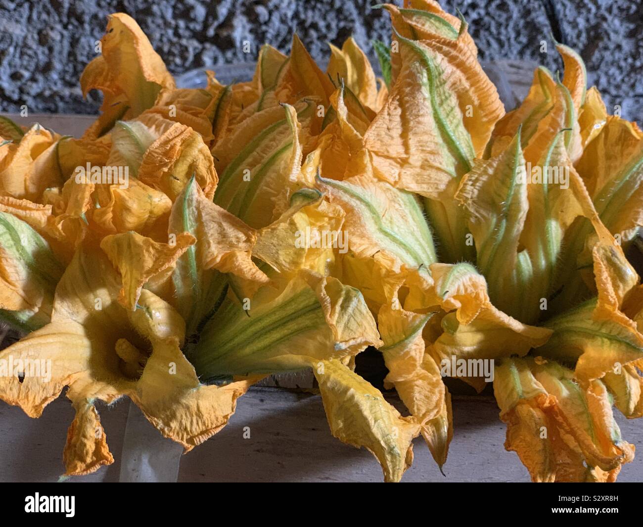 Courgette flowers in a country market Stock Photo