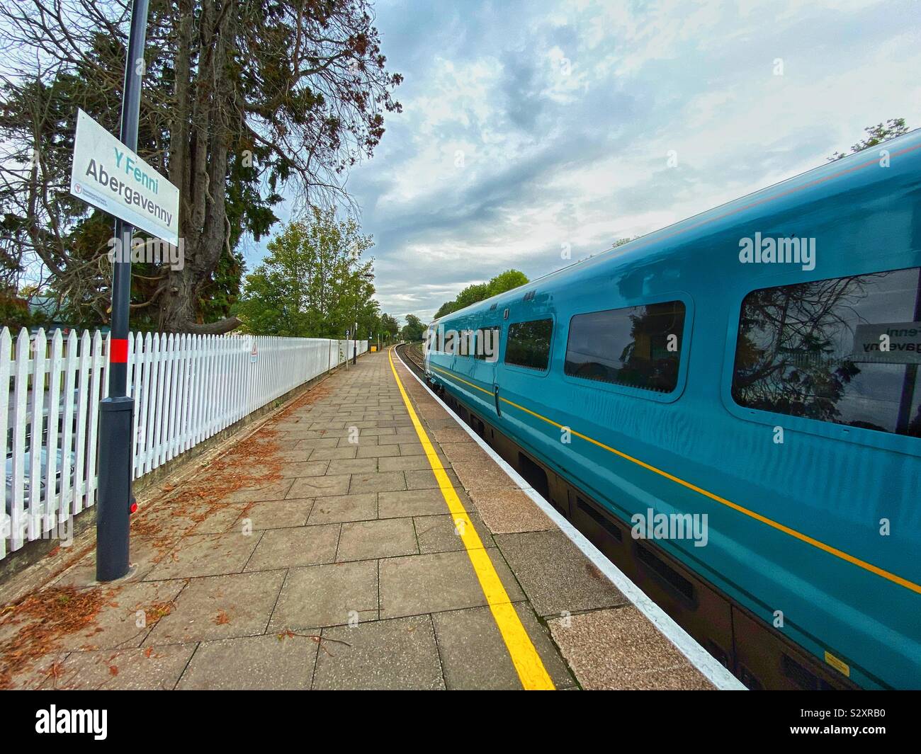 Commuter train alongside empty platform at Abergavenny railway station. The rural town is served by Transport for Wales - Smartphone Captured Stock Image