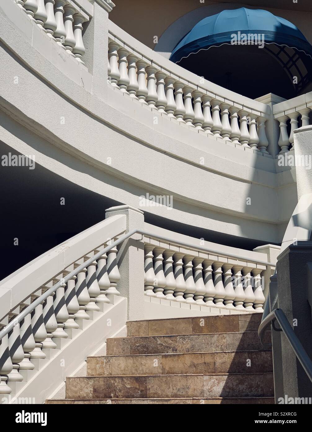 Beautiful outdoor staircase with blue umbrella at the top - Smartphone Captured Stock Image