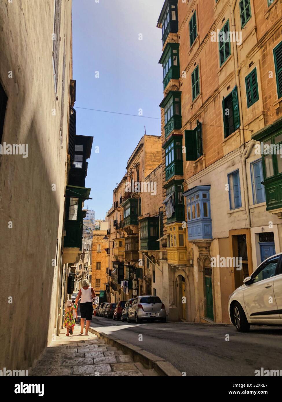 Valletta, Malta; looking down street with sunlight and shadows. Stock Photo