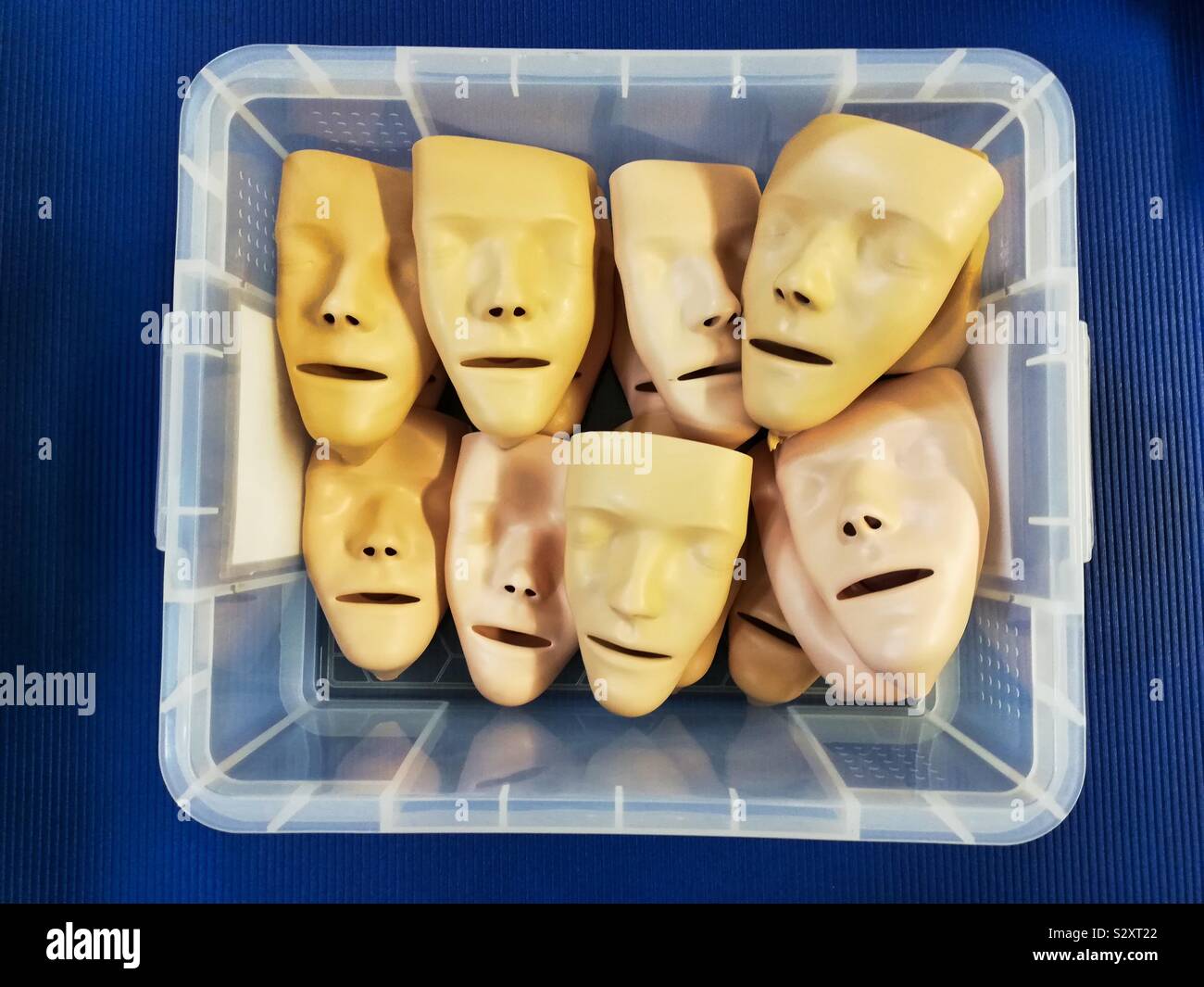 Face masks for a first aid course lie in a storage box. - Smartphone Captured Stock Image