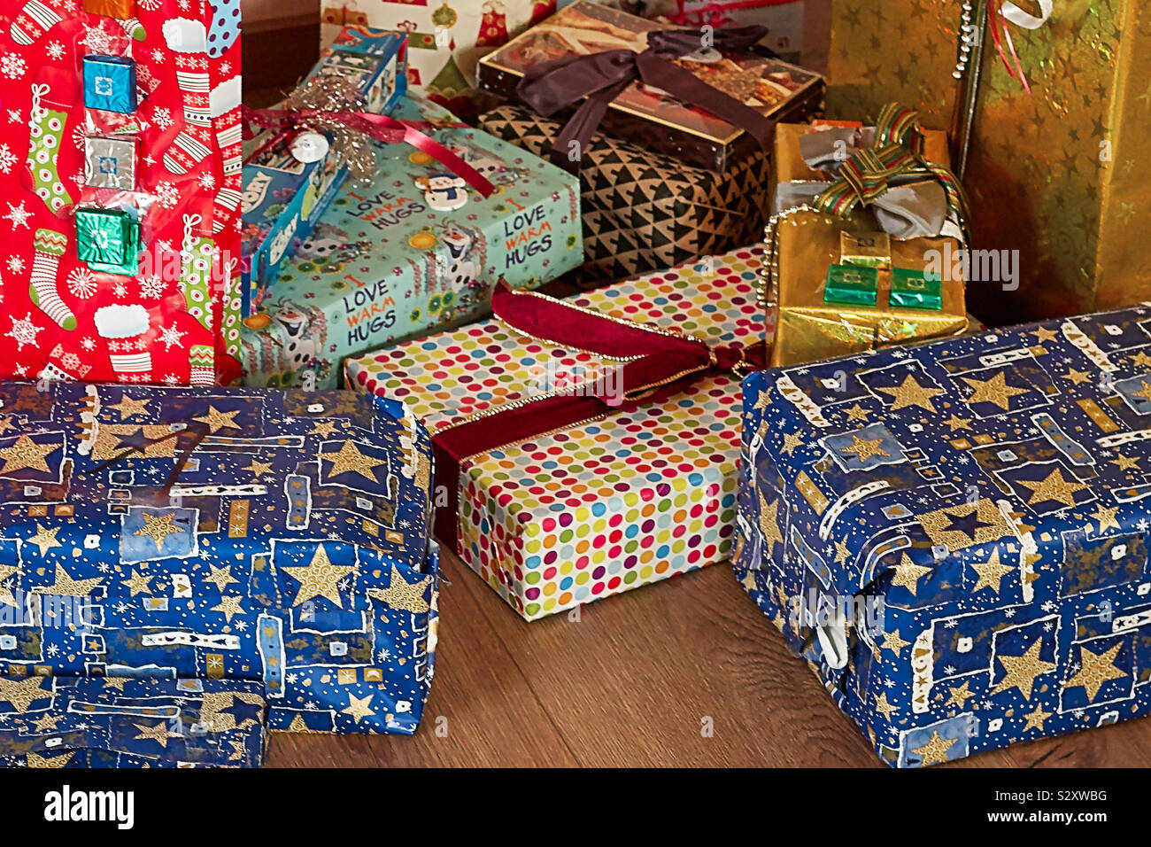 Colourfully packaged Christmas presents and Christmas packages lie on