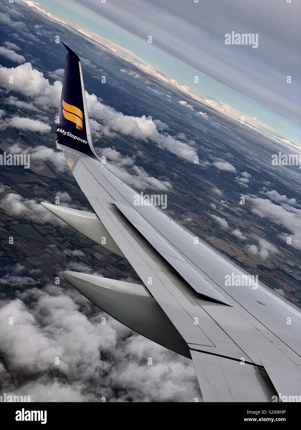 London, UK - September 2019: The wing of an Icelandair Boeing aeroplane as it flies over England heading for Heathrow airport. - Smartphone Captured Stock Image