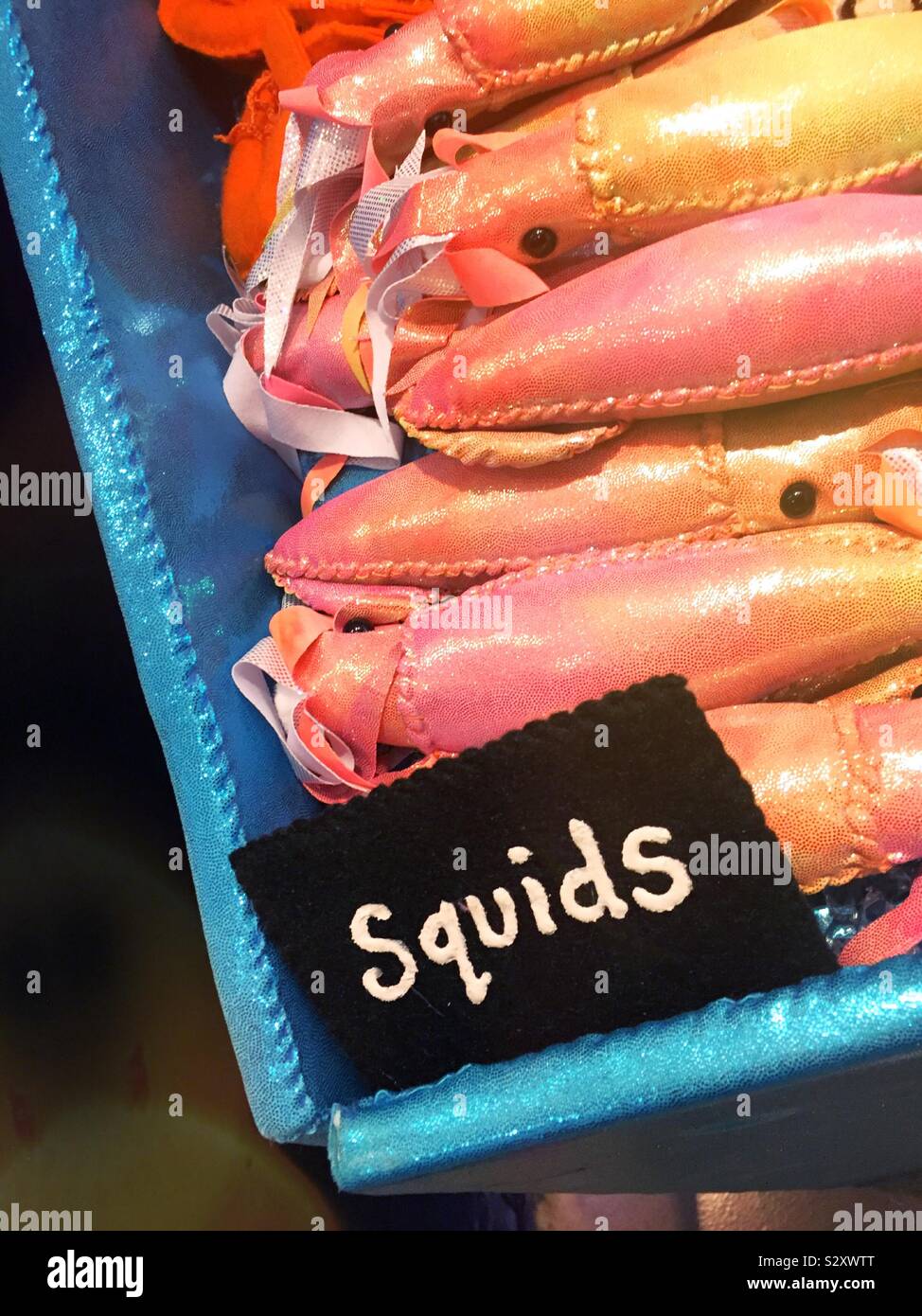 Handsewn felt art pieces in the shape of squids at Lucy sparrows delicatessen on sixth Avenue, NYC, USA - Smartphone Captured Stock Image
