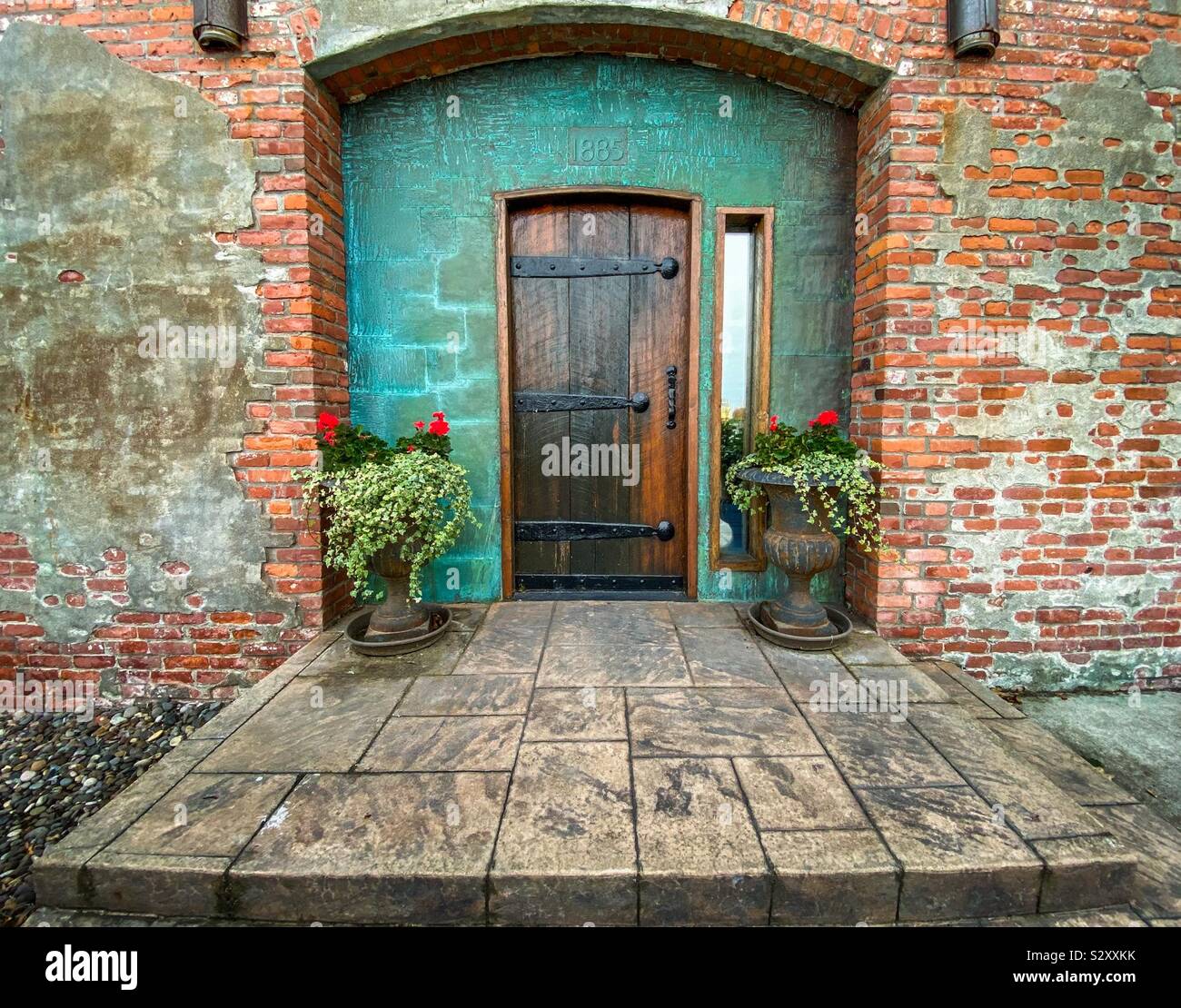Picturesque wooden doorway in historic brick building - Smartphone Captured Stock Image