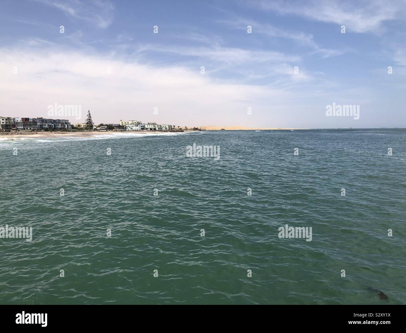 Overlooking the beach from the jetty Stock Photo