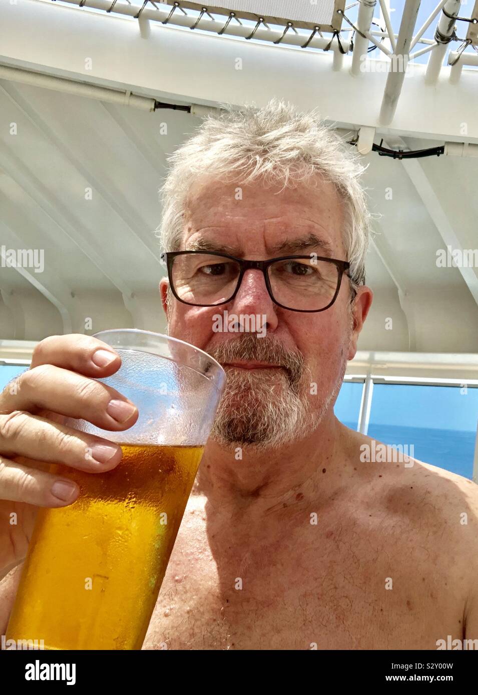 Senior man with raised pint of beer - Smartphone Captured Stock Image