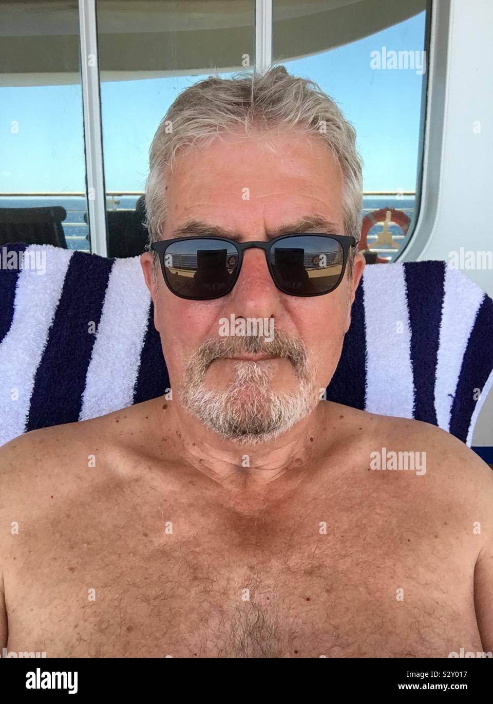 Man in sunglasses looking at camera - Smartphone Captured Stock Image