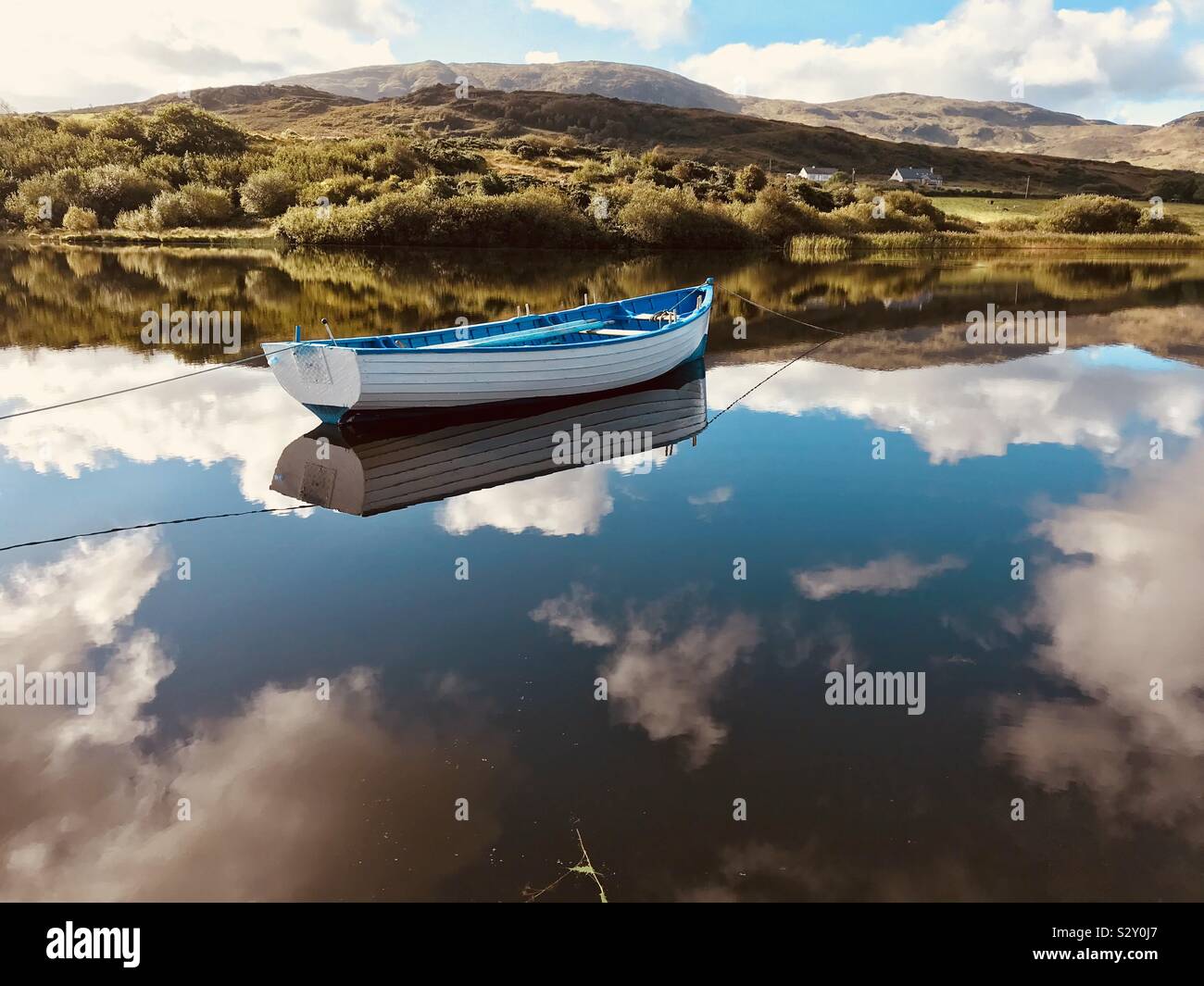 Wooden boat on still lake, County Donegal, Ireland - Smartphone Captured Stock Image
