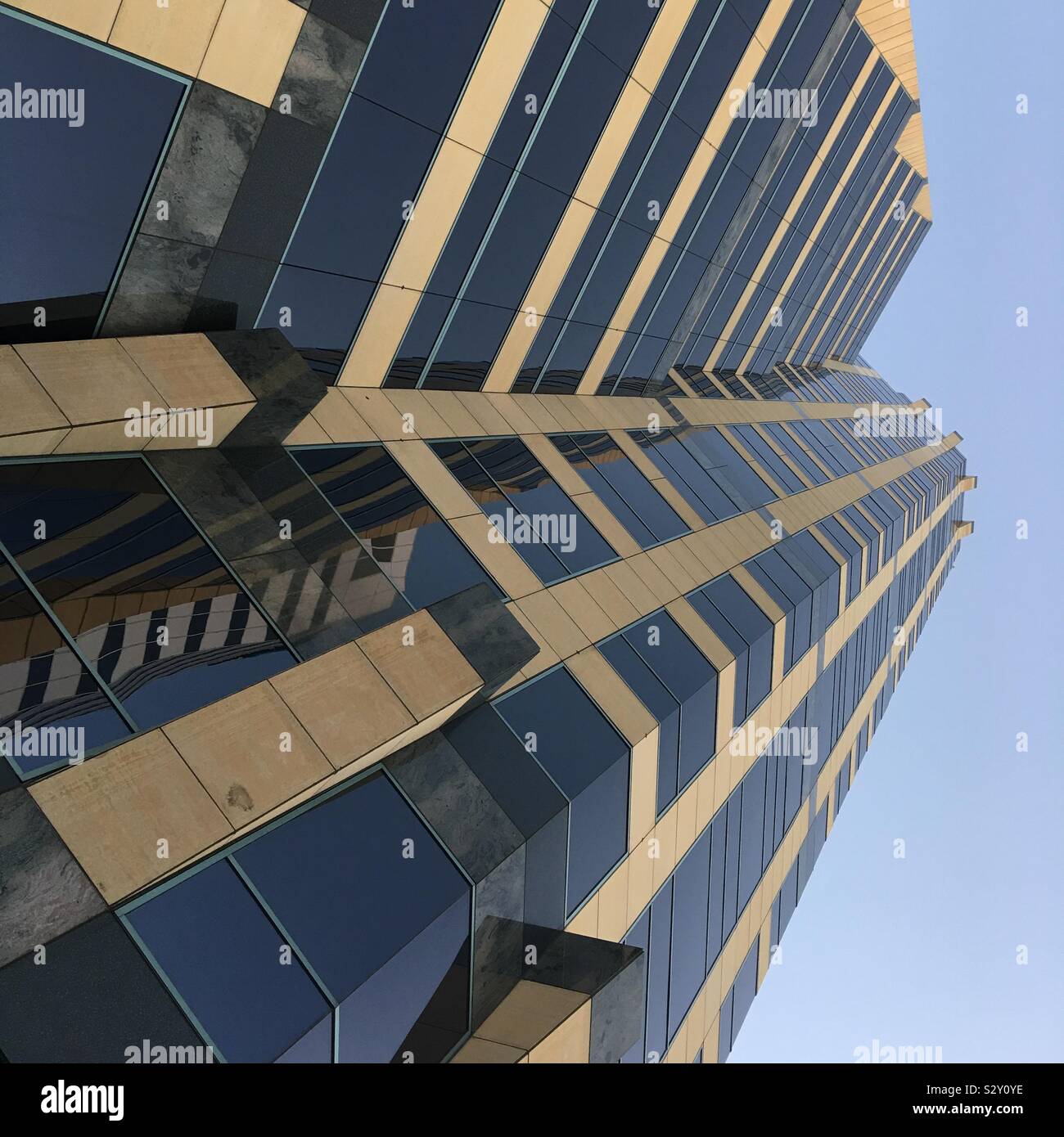 LOS ANGELES, CA, SEPT 2019: looking up at tall office building with blue sky behind, Wilshire Blvd in Westwood area - Smartphone Captured Stock Image