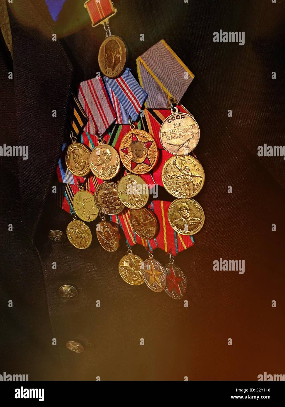 Chest full of Russian metals on a KGB officers uniform chest at the KGB espionage Museum in New York City, USA - Smartphone Captured Stock Image