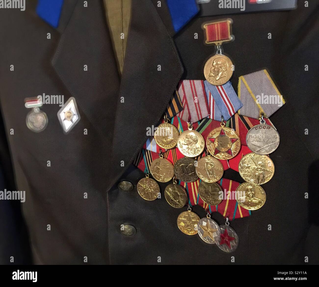 Chest full of Russian metals on a KGB officers uniform chest at the KGB espionage Museum in New York City, USA - Smartphone Captured Stock Image