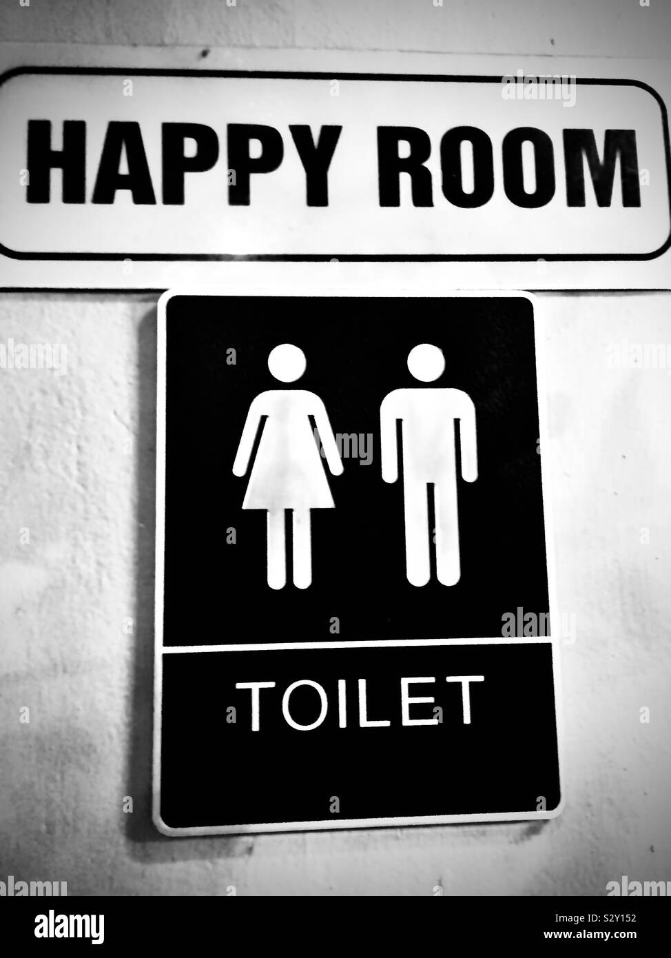 Happiness is relief. Sign to restroom, aka the happy room Stock Photo