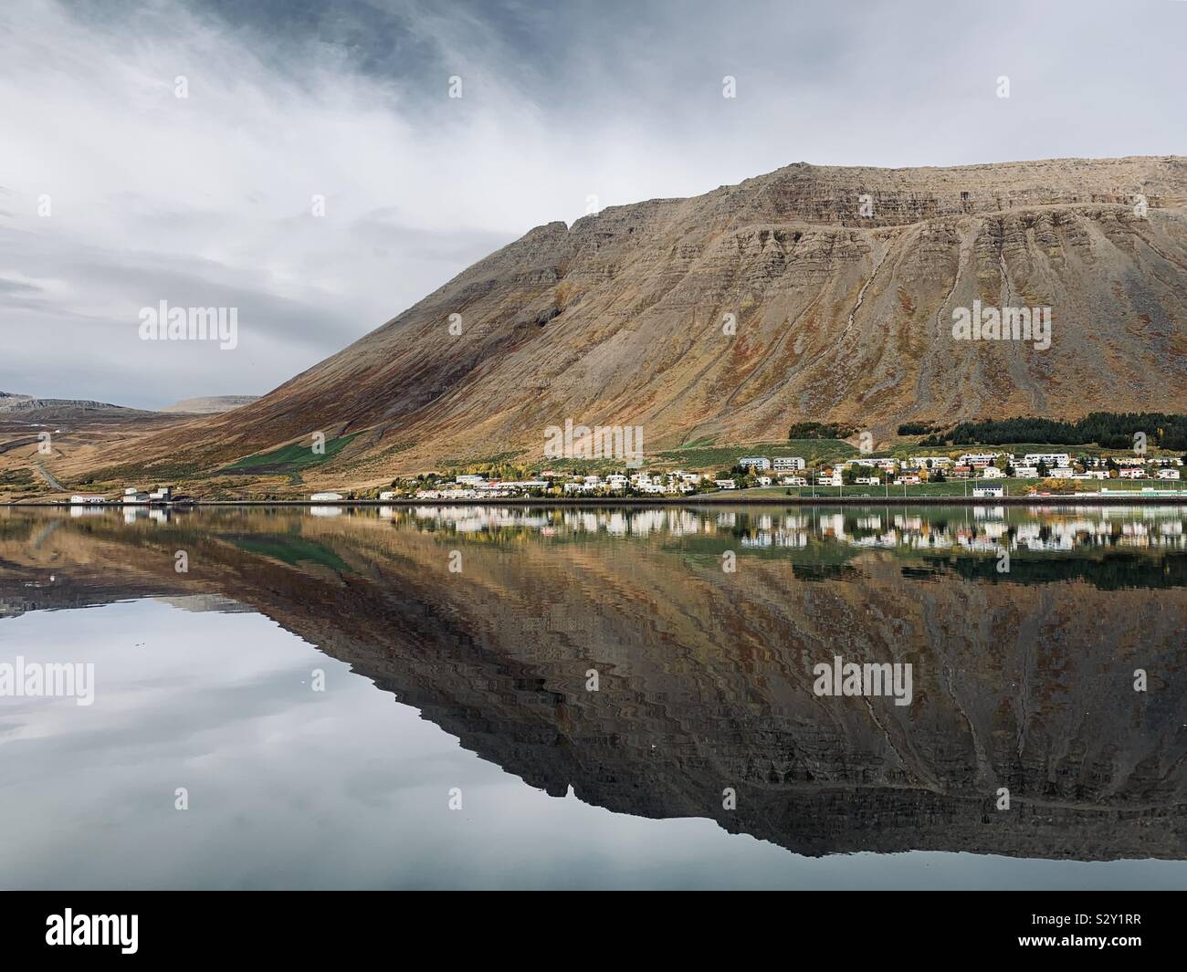 Isafjordur, Iceland - September 2019: Reflections in the still harbour water on an overcast morning in the Western Fjords. - Smartphone Captured Stock Image