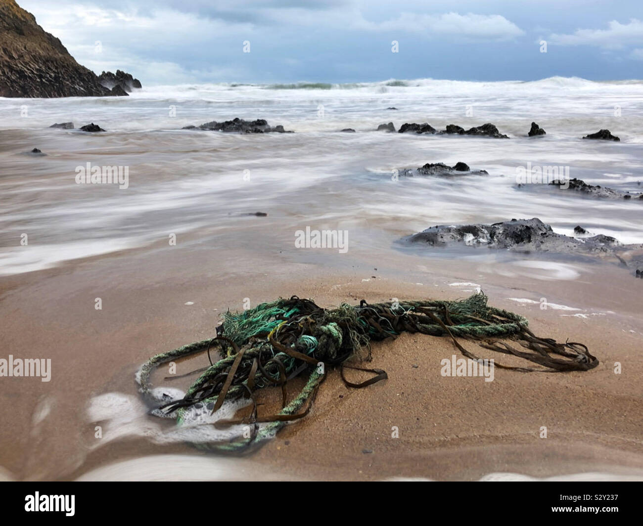 Old rope washed up on a Welsh surf beach, October. - Smartphone Captured Stock Image