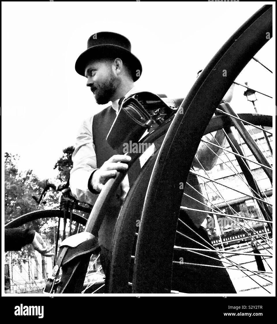 Gentle man in a top hat with his Penny Farthing bicycle - Smartphone Captured Stock Image