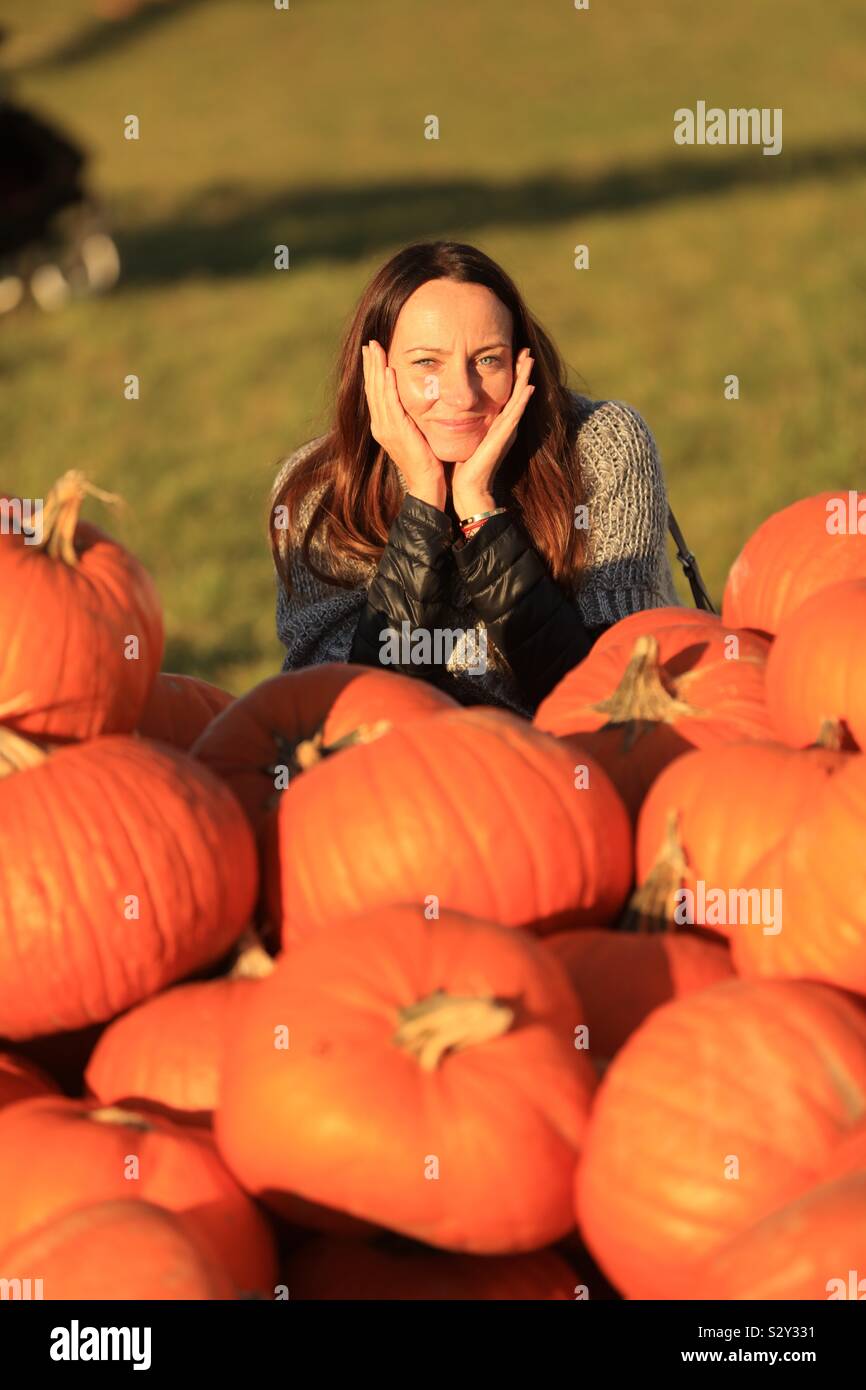 Woman with pumpkins Stock Photo