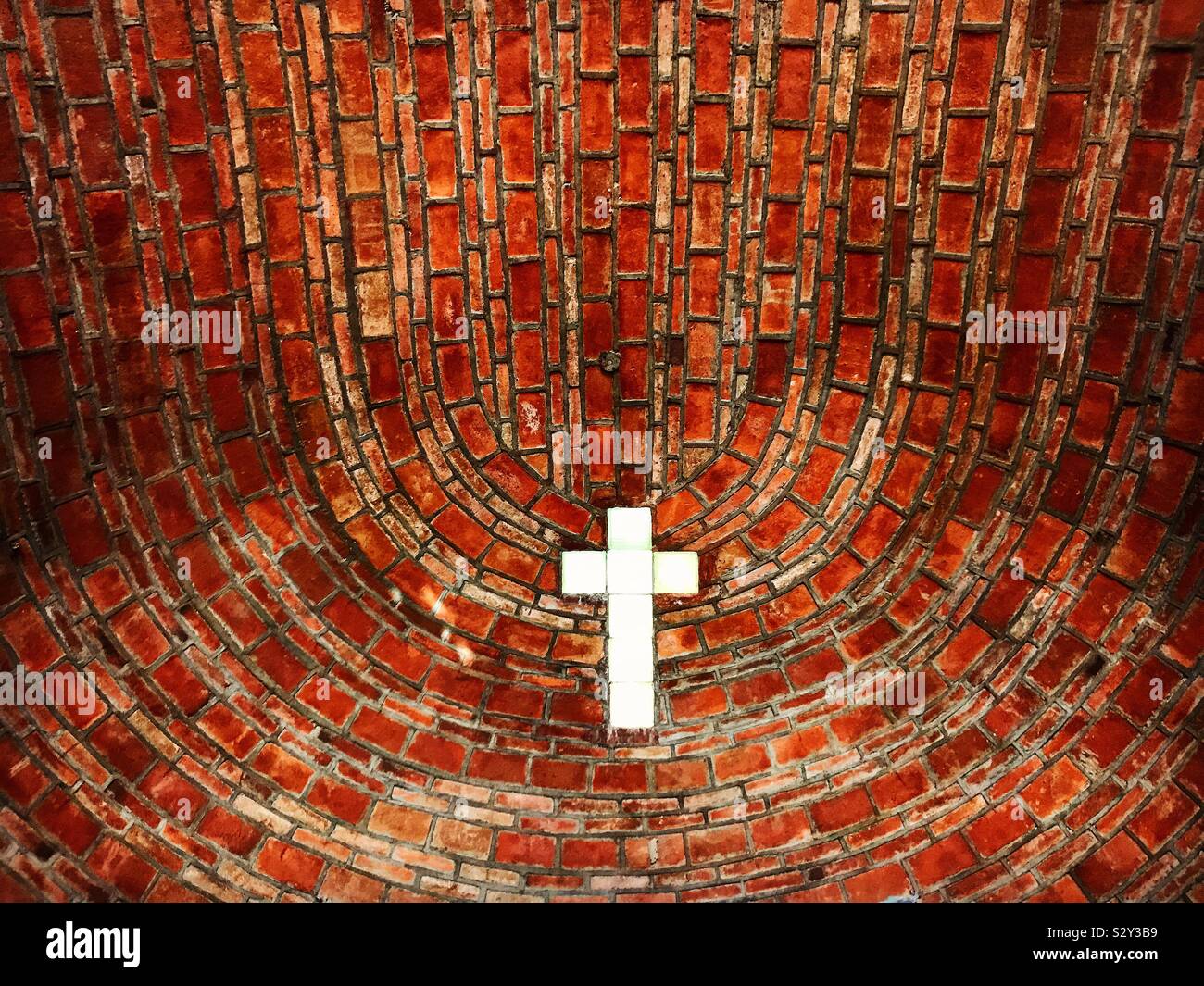 A window with the shape of a cross decorates a chapel in Tonatico, Mexico State, Mexico - Smartphone Captured Stock Image