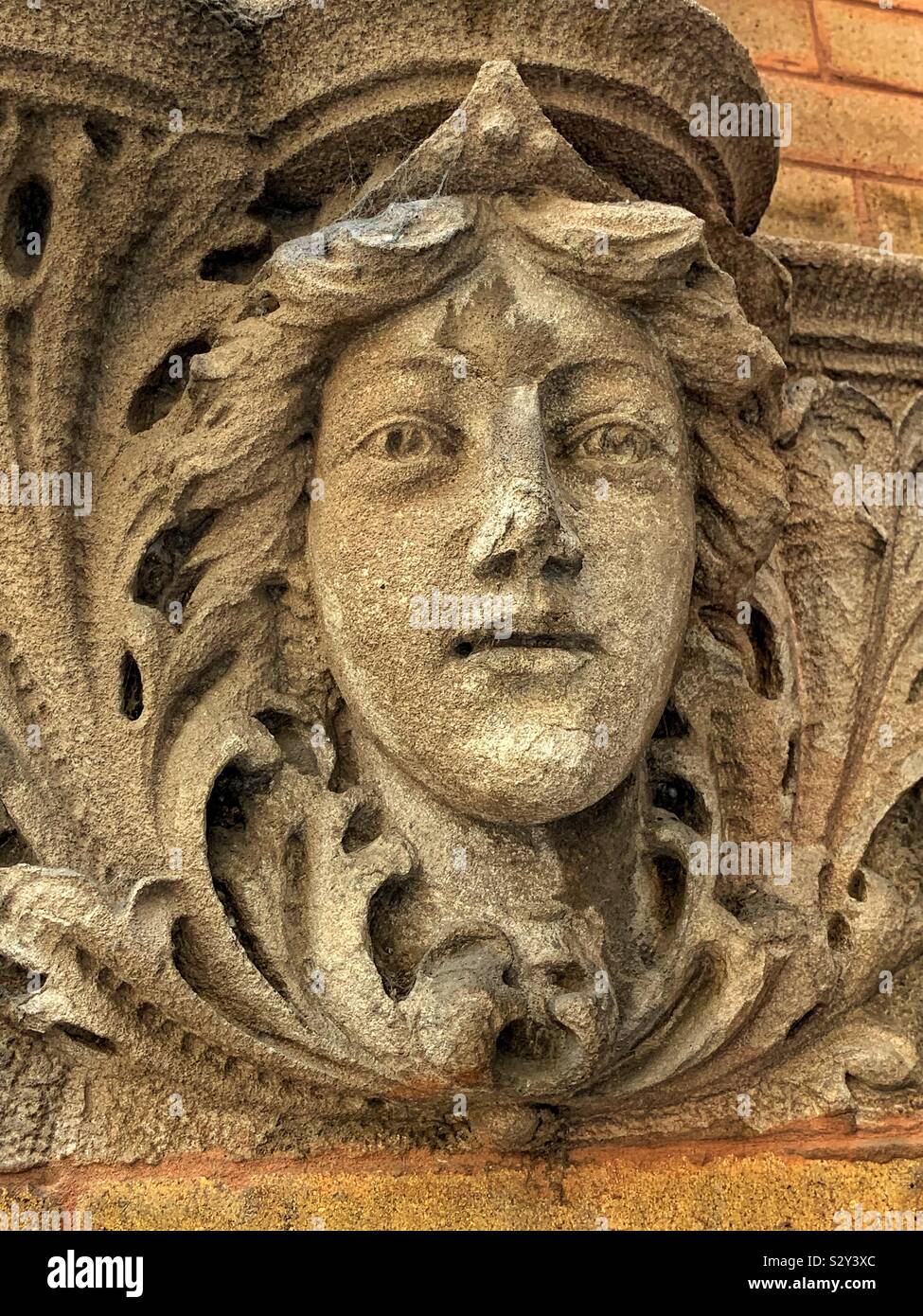 Stone sculpture building facade of a beautiful young woman. - Smartphone Captured Stock Image