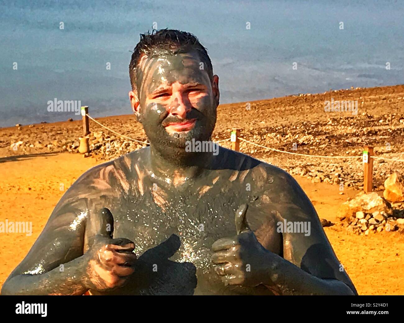 Getting clayed up at the Dead Sea - Smartphone Captured Stock Image