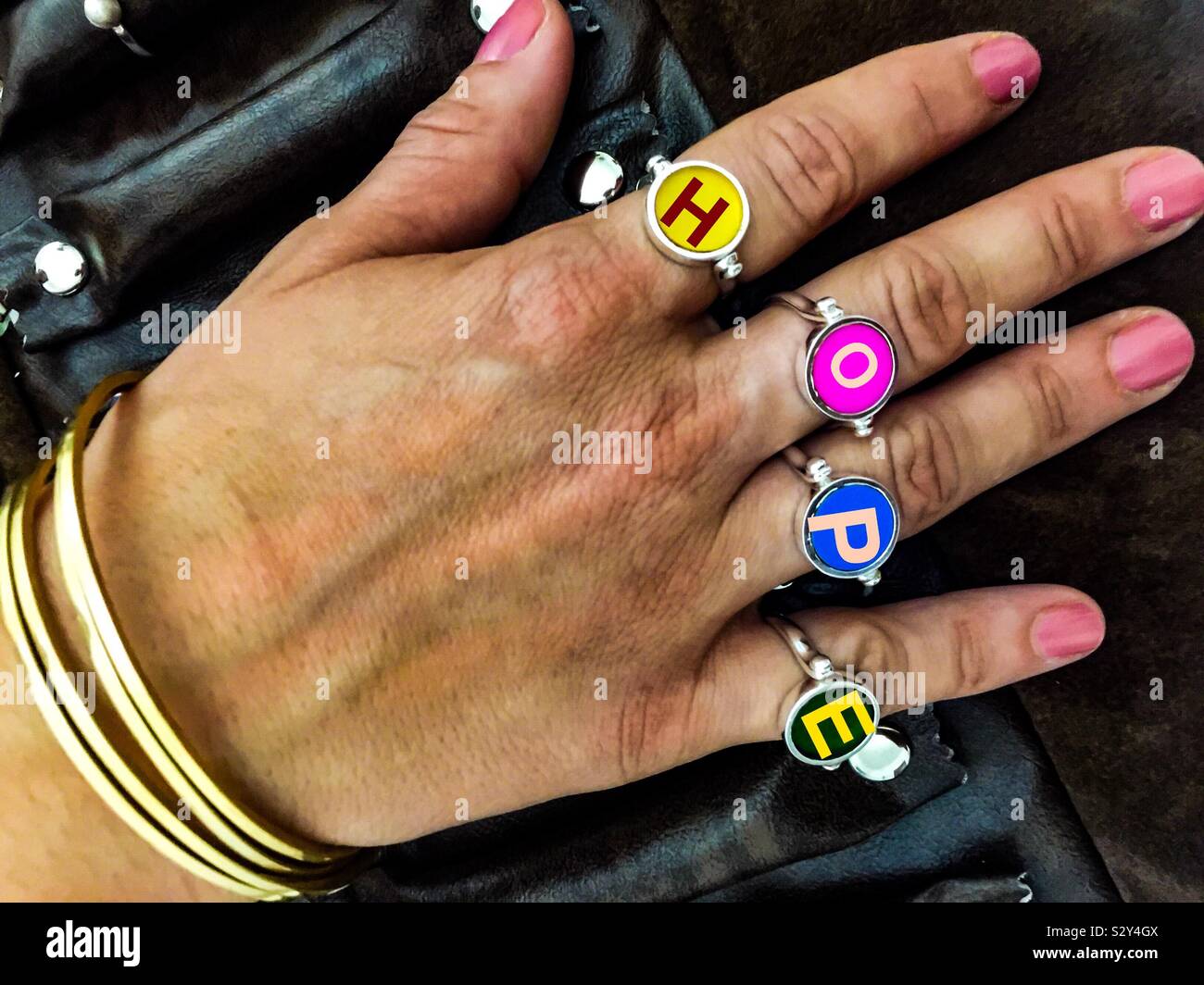 HOPE Jewellery, rings made from recycled vinyl albums, LPs, original colours, stylish,spell out hope, the best four letters in English. Four-lettered - Smartphone Captured Stock Image