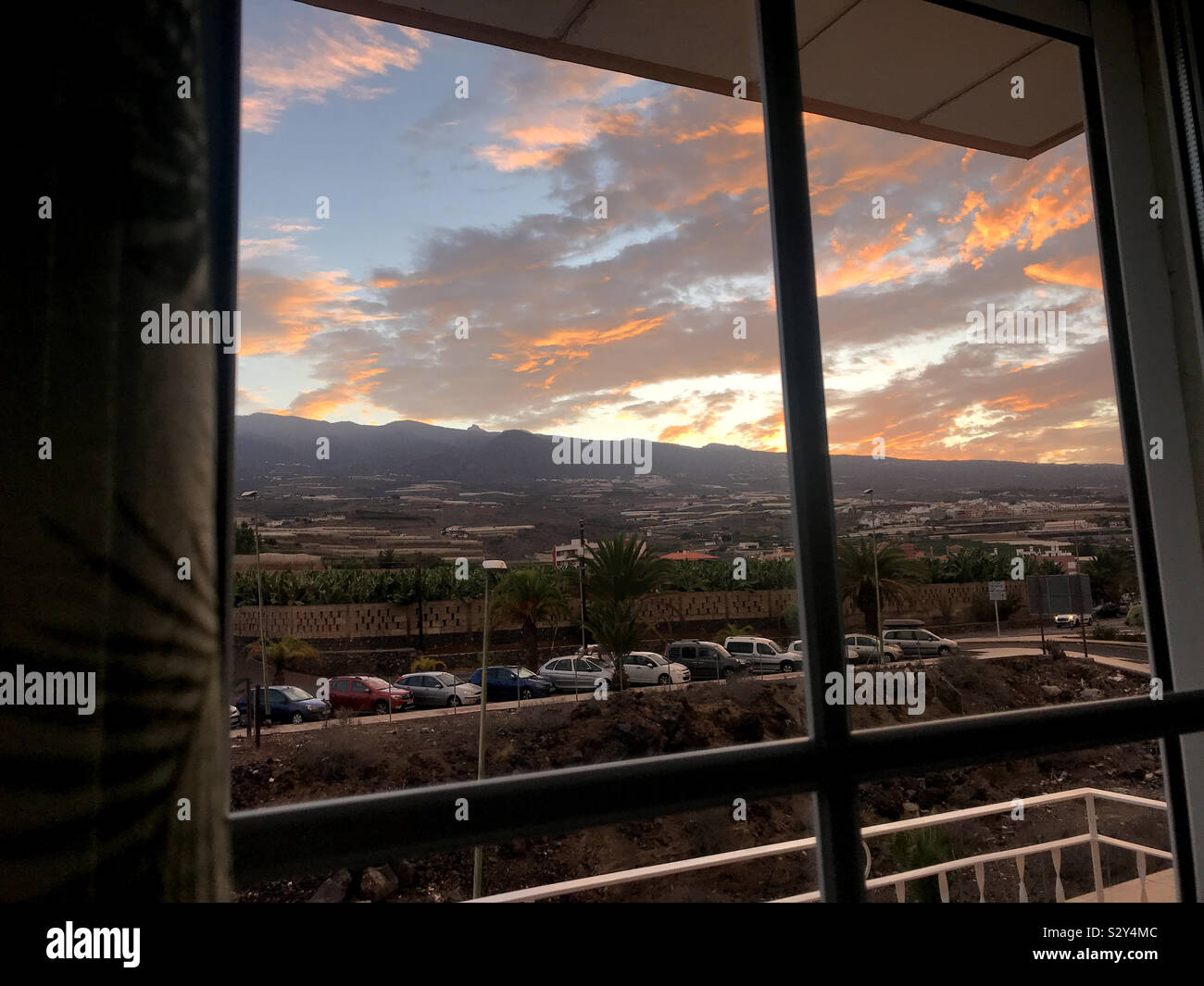Red sky in the morning through window in Tenerife, Canary Islands - Smartphone Captured Stock Image