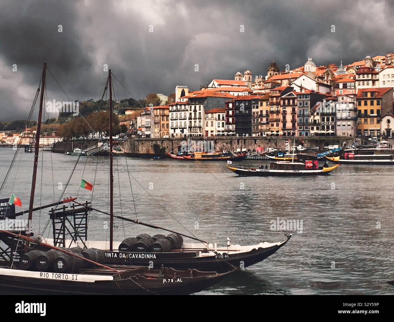 Stormy river, Porto, Portugal. Traditional rabelo tourist boat in foreground Stock Photo