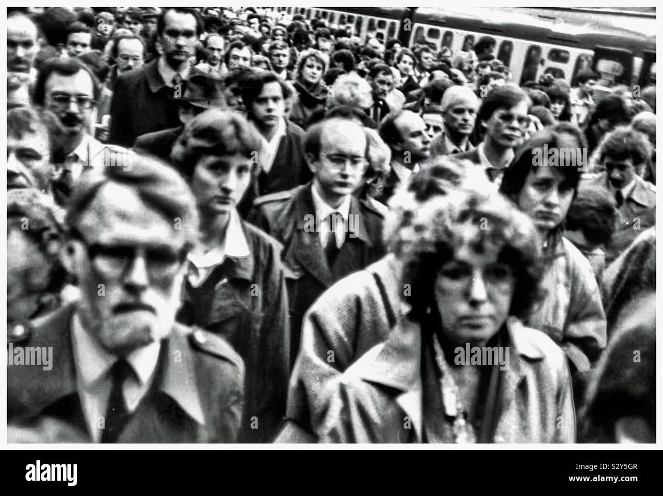 Glum commuters at a London train station in the 1980’s. - Smartphone Captured Stock Image