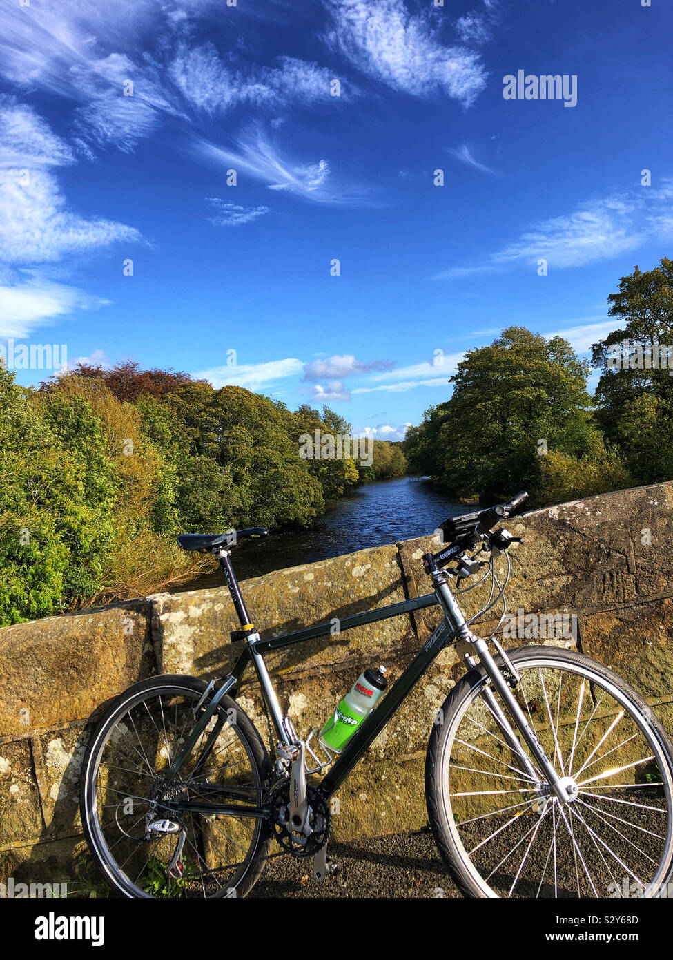 Mountain bike by the River Wharfe on an sunny autumn day in Ilkley West Yorkshire Stock Photo