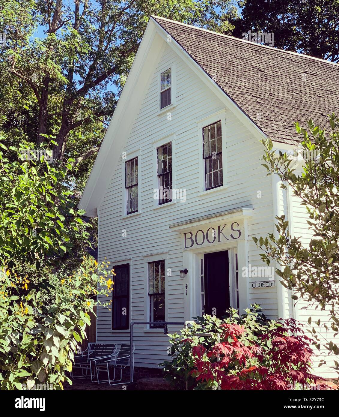 A home in Wellfleet, Cape Cod, Massachusetts, United States. The “Books” sign over the front door remains although the building no longer includes bookstore. - Smartphone Captured Stock Image