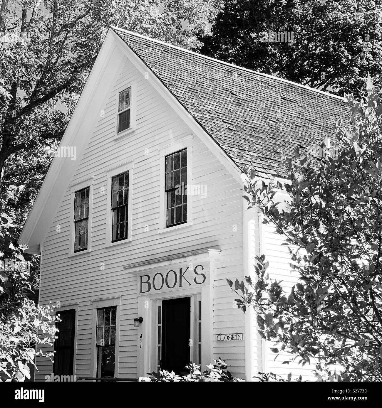 A home in Wellfleet, Cape Cod, Massachusetts, United States. The “Books” sign over the front door remains although the building no longer includes bookstore. - Smartphone Captured Stock Image