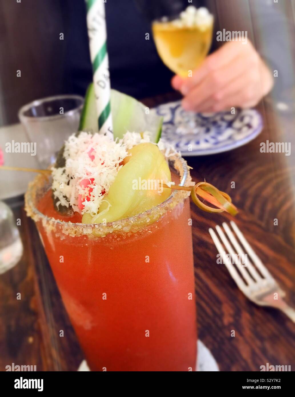 A brightly garnished bloody Mary on a table in Greenwich Village restaurant, NYC, USA - Smartphone Captured Stock Image