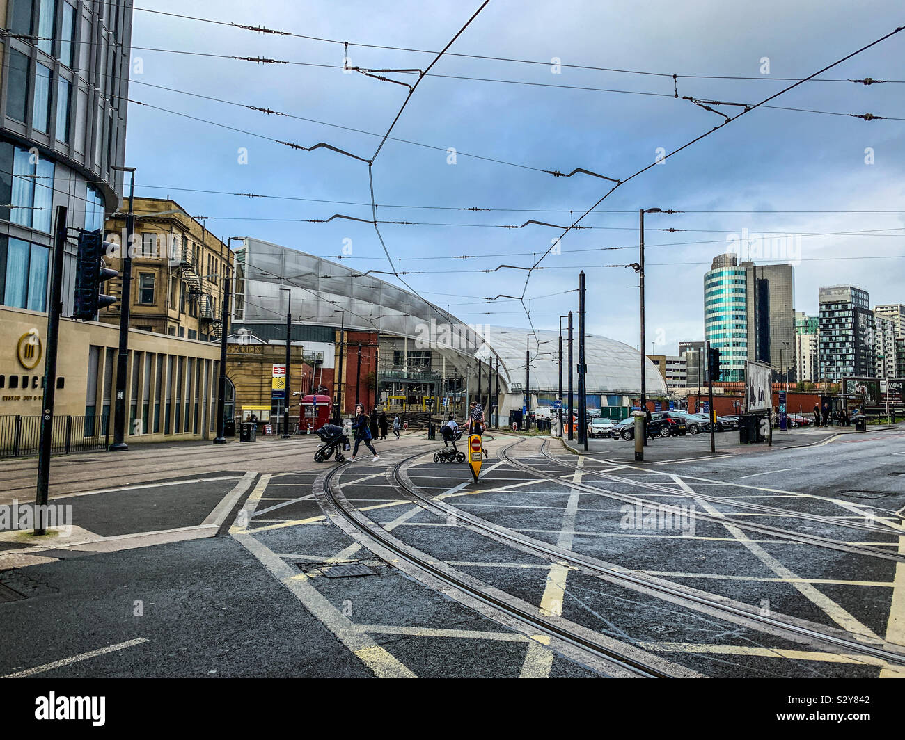 Tram lines and overhead cables near Victoria Train Station in Manchester Stock Photo