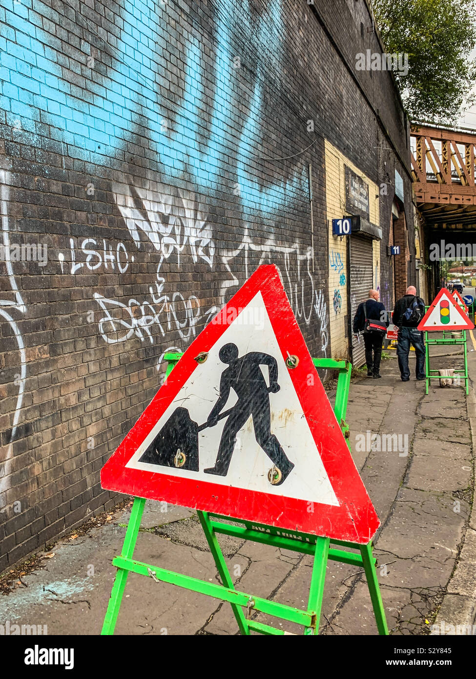 Men at work traffic sign in urban Manchester - Smartphone Captured Stock Image