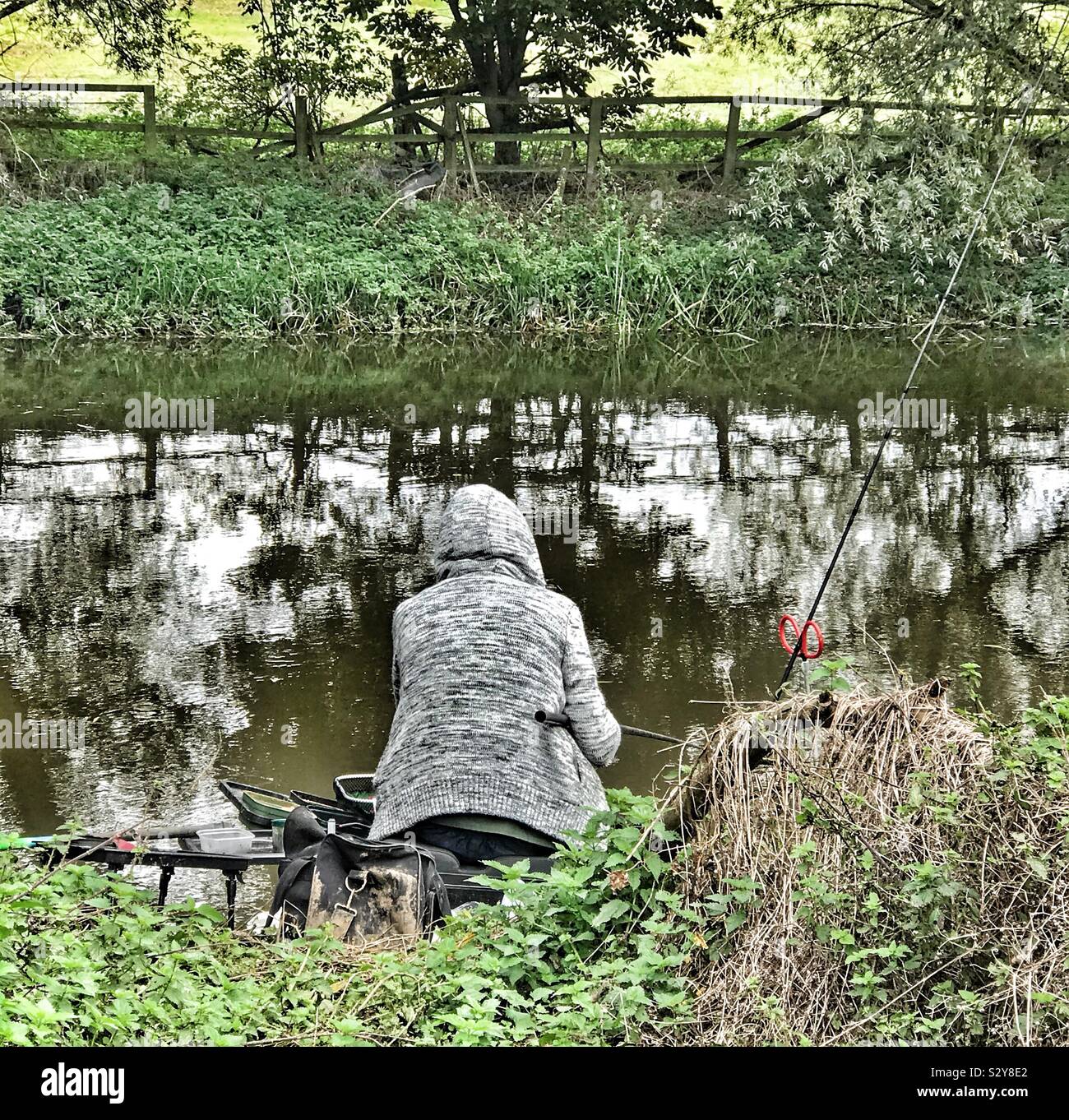 Man Fishing on the banks of the River Ouse Bedfordshire - Smartphone Captured Stock Image