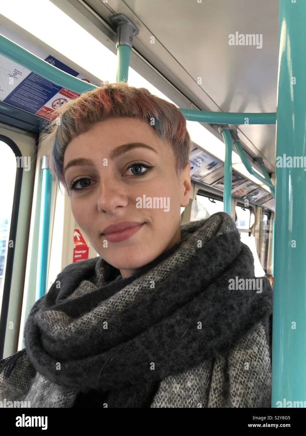 Portrait of young woman with multicolored short hair on London Underground - Smartphone Captured Stock Image
